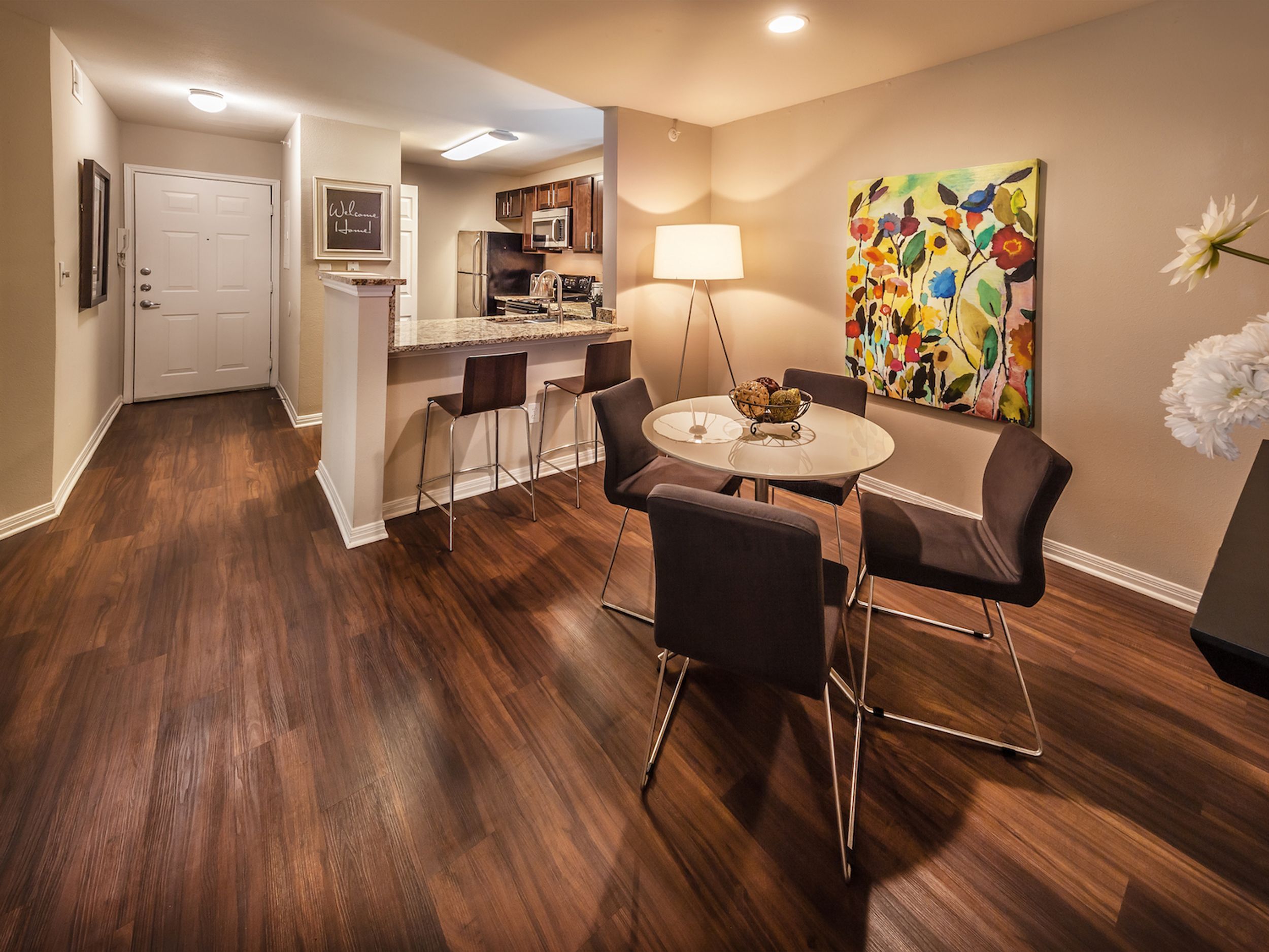 Dining room and kitchen with view of apartment entrance