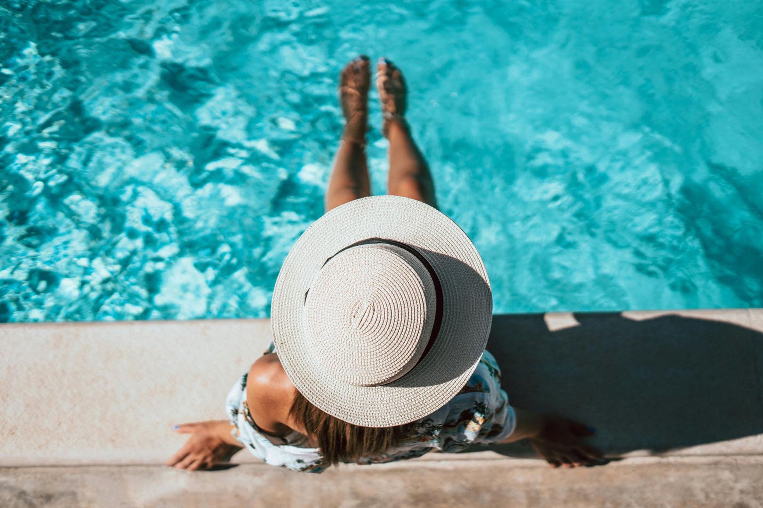 woman at pool with hat on