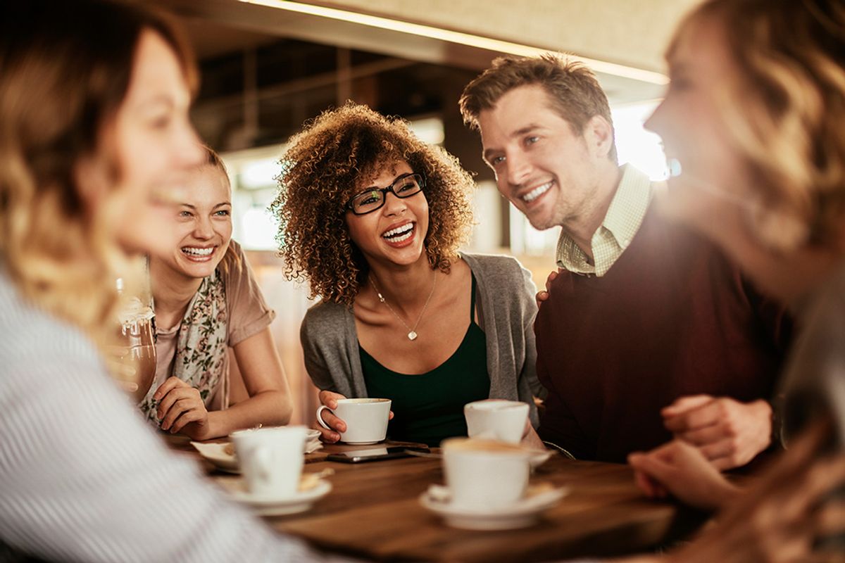 group smiling while drinking coffee