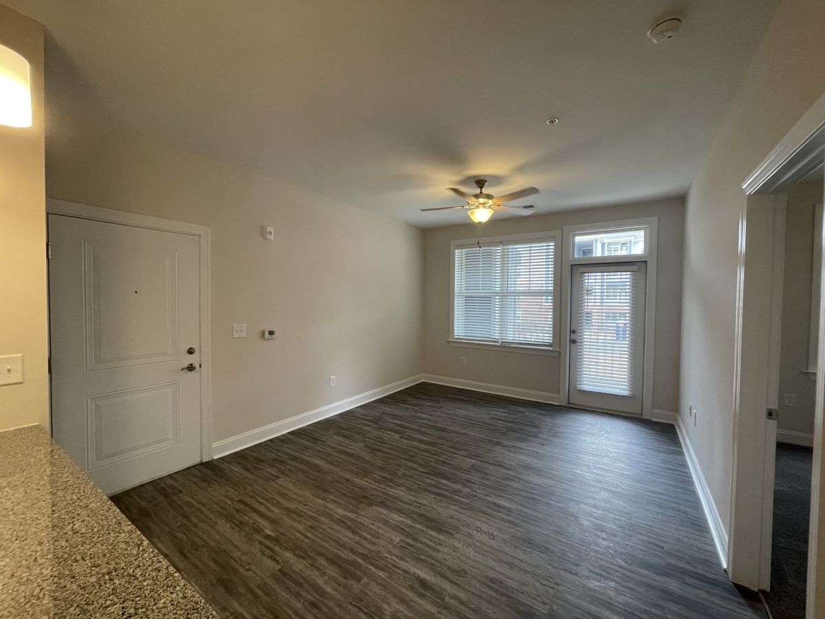 Living room with exit to  patio in our 1 bedroom 1 bathroom floorplan. 