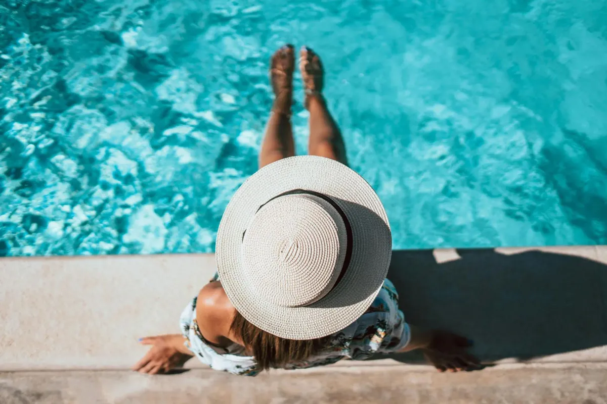 woman at pool with hat on