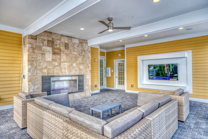 outside lounge area with fireplace and tv